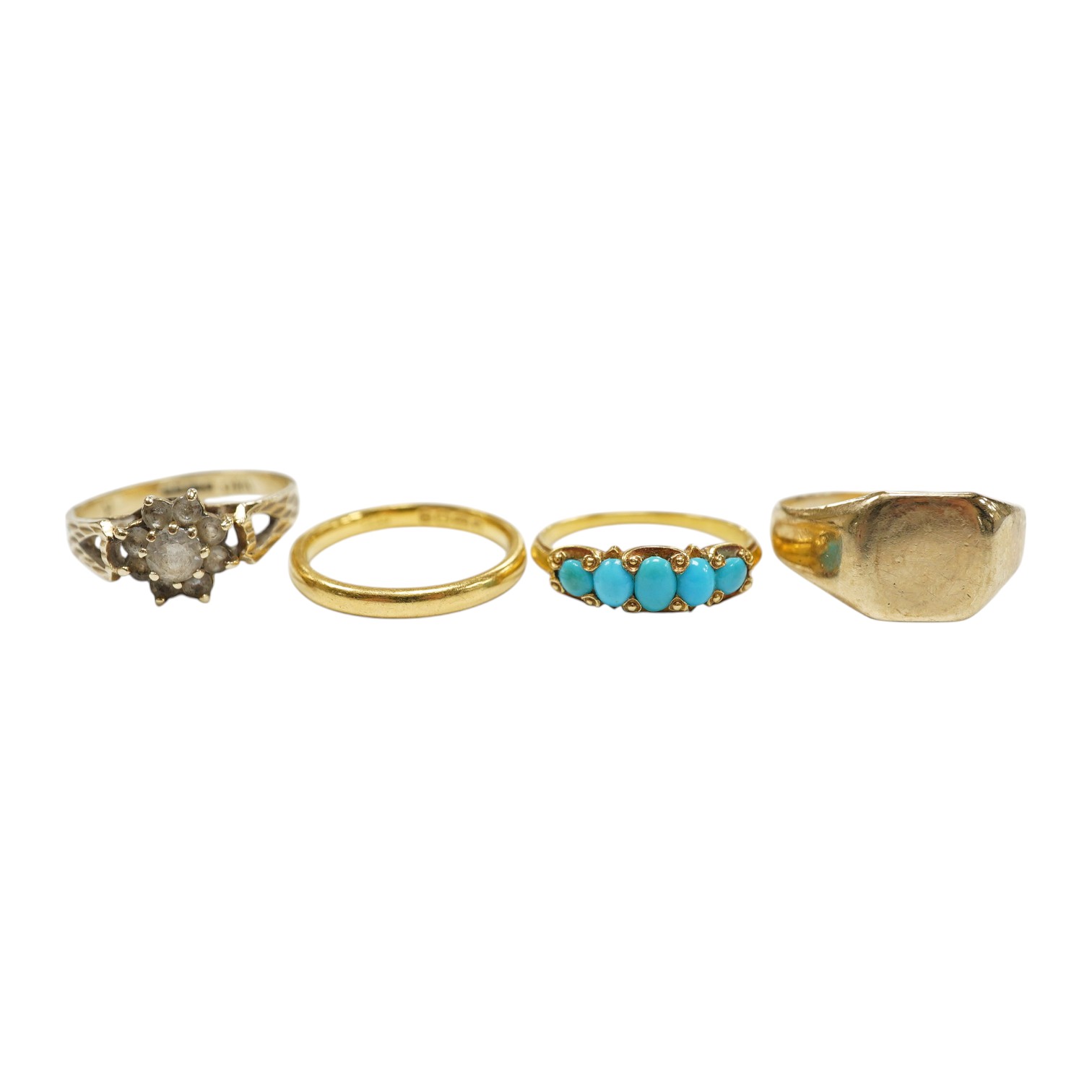 Four assorted rings, including a 22ct gold wedding band, 3.2 grams, two 9ct gold rings including a signet ring and a yellow metal and graduated five stone turquoise set half hoop ring, gross weight 7.3 grams. Condition -